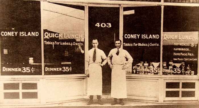 John Mitsos and George Papazekos standing in front of Coney Island Restaurant, New Castle, Pennsylvania circa 1932