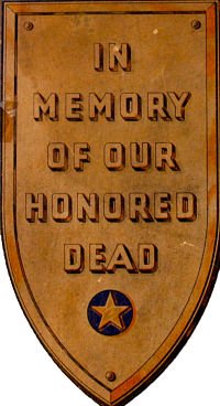 Gold shield with the words In Memory of our Honored Dead. There is a military star at the bottom of the shield.