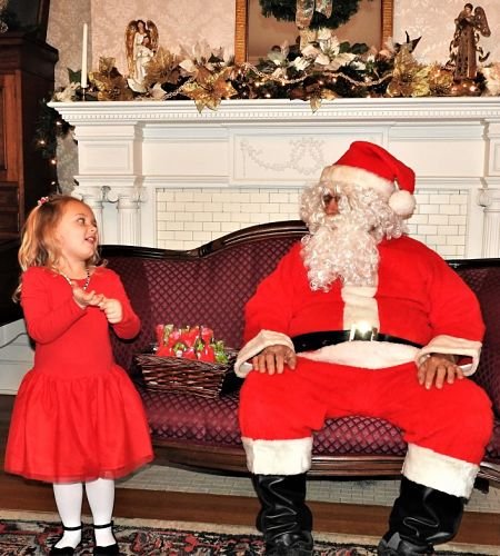 Little girl talking with Santa Claus