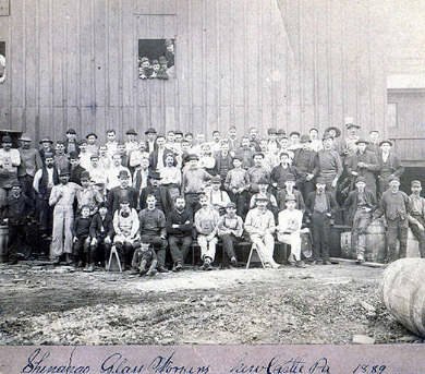 Shenango glass workers sitting outside factory, 1889.
