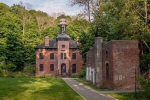 Historic West Point Foundry surrounded by trees.